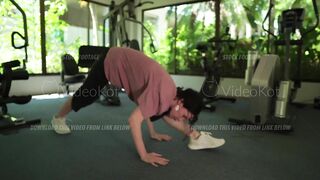 Woman is doing warming up and stretching in the gym before intense workout