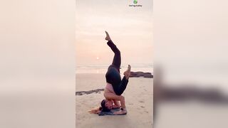 Upside down Yoga asana on the beach #yogaurmi