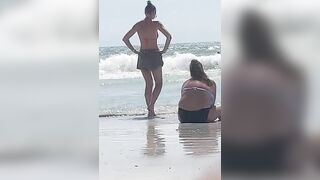 Fat white girl and skinny white girl in bikinis on beach.