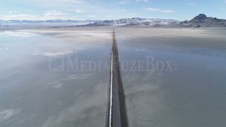 Stock Video - Flying over long road stretching over the Bonneville Salt Flats during flood