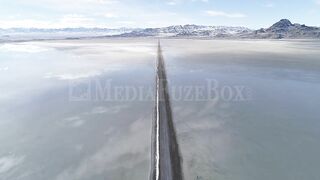 Stock Video - Flying over long road stretching over the Bonneville Salt Flats during flood