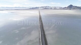 Stock Video - Flying over long road stretching over the Bonneville Salt Flats during flood